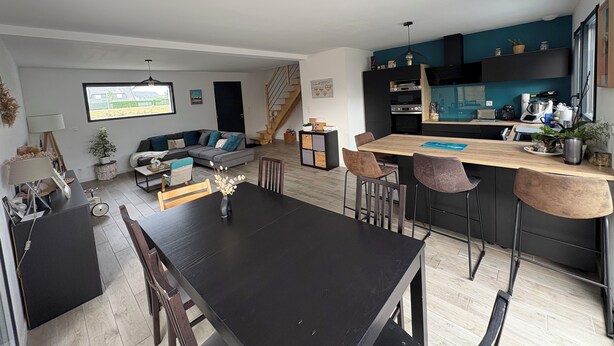 A modern living room with a sofa, coffee table, and TV. A kitchen area with a dining table and chairs is visible. - Recent house in Séné, at the gateway to the Gulf of Morbihan, 5 minutes from the Port of Vannes (Séné)