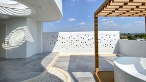 A modern rooftop terrace with a white bathtub, a wooden pergola, and a patterned wall. - The Pool Space — ICONIC Pool Villa (Pattaya)