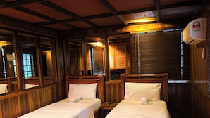 A hotel room with two single beds, wooden paneling, a large mirror, and a ceiling fan. - HOTEL I VILLA INN (Kuala Lumpur)