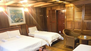 A hotel room with two beds, a wooden ceiling, a wicker chair, and a small table. - HOTEL I VILLA INN (Kuala Lumpur)