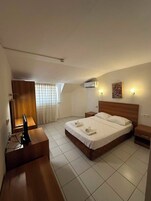 Economy Double Room, City View | Minibar, bed sheets