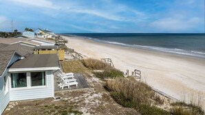 A beachfront property with a beach house, a small pool, and a wooden deck. - Blue Horizon House - 3BR Oceanfront (Ponte Vedra Beach)