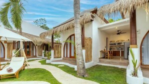 A resort with thatched-roof structures, a pool, and a dining area. - Roh Villas Kuta Lombok (Kuta)