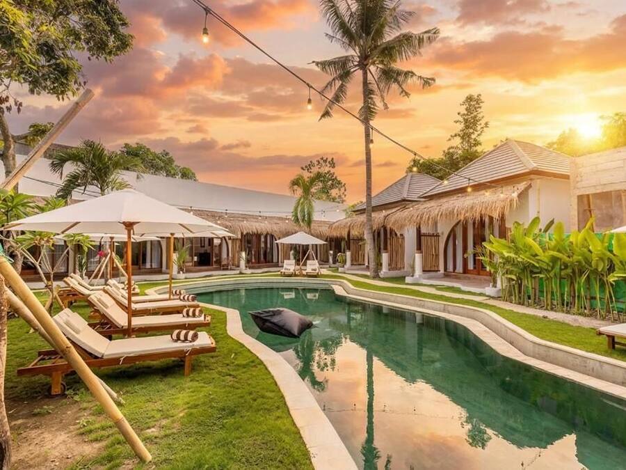 Una piscina al aire libre, sombrillas, tumbonas