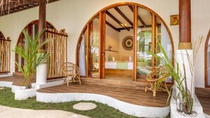 A room with a bed, a window, and a wooden ceiling. - Roh Villas Kuta Lombok (Kuta)
