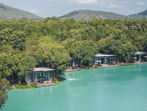 A resort with multiple buildings surrounded by lush greenery and a turquoise pool. - Samui Fishing Club & Resort (Koh Samui)