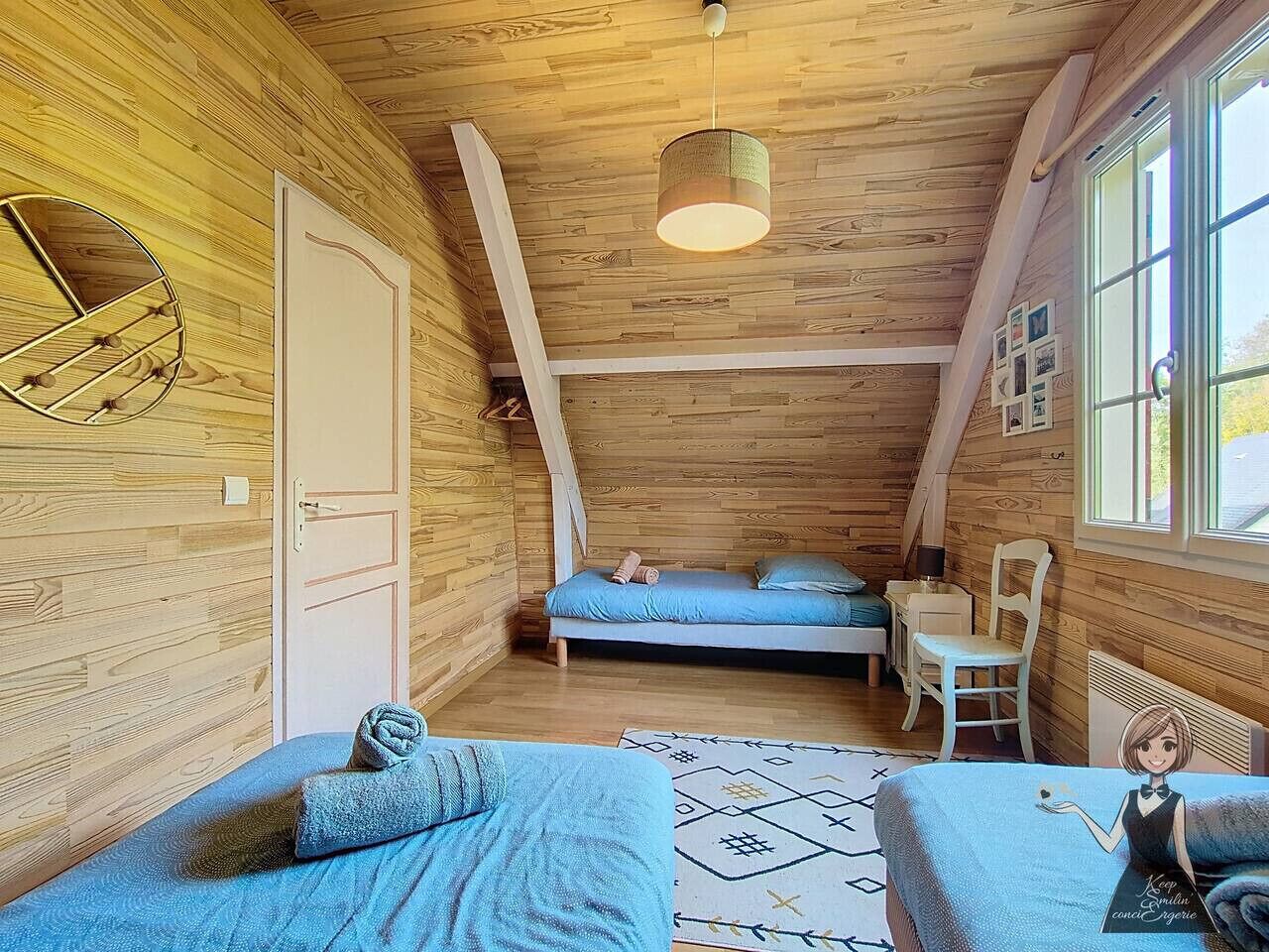A cozy wooden cabin bedroom with two beds, a desk, and a chair.