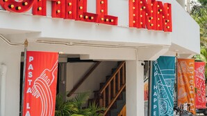 A building with a sign that reads 'CHILL INN' and a banner with 'PETA LANTA BABY' text.