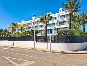 A modern building with a white facade, multiple floors, and balconies. - Bright Apartment with Expansive Poolside Balcony (Mar de Cristal)