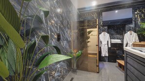 A spa area with a marble wall, a sauna, and a reception desk. - Private Luxury Spa Suite: Sauna, Jacuzzi, Ice Bath (Burton upon Trent)