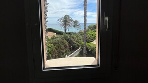 Een uitzicht op een palmboom, een trap en een strand.
