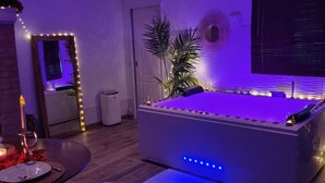 A billiards table with LED lights, a mirror, a potted plant, and a candle on a table. - Luxury suite with private Jacuzzi and garden 20 minutes from Paris NetFlix (Saint-Prix)