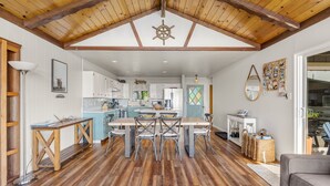 A spacious kitchen with white cabinets, a central island, and a wooden ceiling. - Irish Beach | Ocean Views, Hot-tub, Beach Access (Manchester)