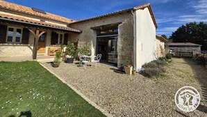 A rustic house with a tiled roof, a stone exterior, and a gravel driveway. - Charming lodging in Coursac - 2 guests (Coursac)