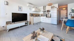 Eine moderne Wohnung mit Wohnzimmer, Küche und Essbereich.