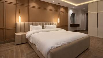 A modern bedroom with a large bed, nightstands, a mirror, and built-in wardrobes.