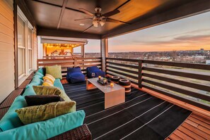 A balcony with a sofa, chairs, a table, and a view of the cityscape. - Private Pool Game Room Compound Minutes to Broadway (Nashville)