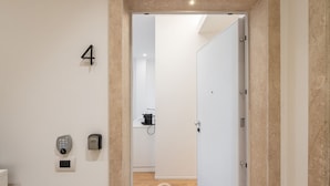 A modern interior with a door marked '4', a keypad, and a lock on the wall. - Loft 4 Via Campidano – Your city-centre retreat (Cagliari)