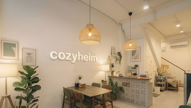 A cozy interior with a dining area, a reception desk, and a staircase.