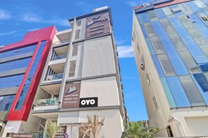 A modern building with signage for luxury rooms, banquet hall, and restaurant. - Hotel O by OYO New Hotel Hamsa (Hyderabad)