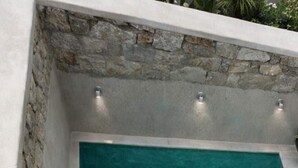 A clear, rectangular hot tub with steps leading into it, surrounded by stone walls and a white tiled floor. - Eidolion Essence Mykonos Villa w Private Pool up to 10 ppl (Mykonos)