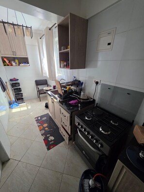 A kitchen with a stove, cabinets, and a sink. - Lovely 1-bedroom apartment in tranquil Nairobi perfect for your stay (Nairobi)