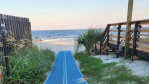 A pathway leading to a beach with a wooden boardwalk on the right and a fence on the left. - Myrtle Beach Resort 6306 (Myrtle Beach)