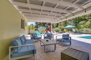 A covered outdoor seating area with a pool, lounge chairs, and umbrellas. - 5 Mi to Beaches! Family Home in Fort Lauderdale (Fort Lauderdale)