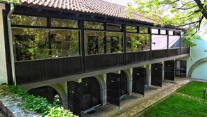 A building with a tiled roof, large windows, and a covered walkway. - Jazina Hotel (Jazina)
