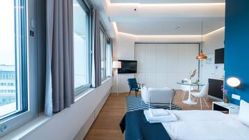 Een moderne hotelkamer met een groot bed, een bureau, een stoel en een televisie.