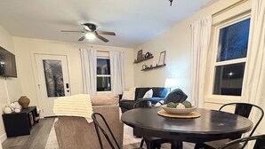 A dining area with a round table, chairs, a chandelier, and a ceiling fan. - Sage & Cedar
Cozy home ready for your stay (Webb City)