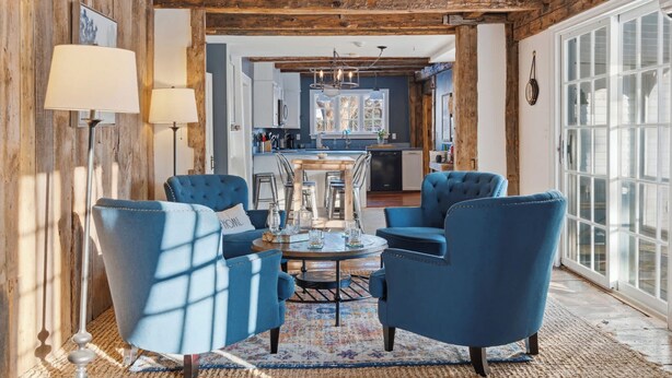 A cozy living room with blue armchairs, a coffee table, and a fireplace. - Spacious Farmhouse Near the Beach Circa 1860 (Biddeford)