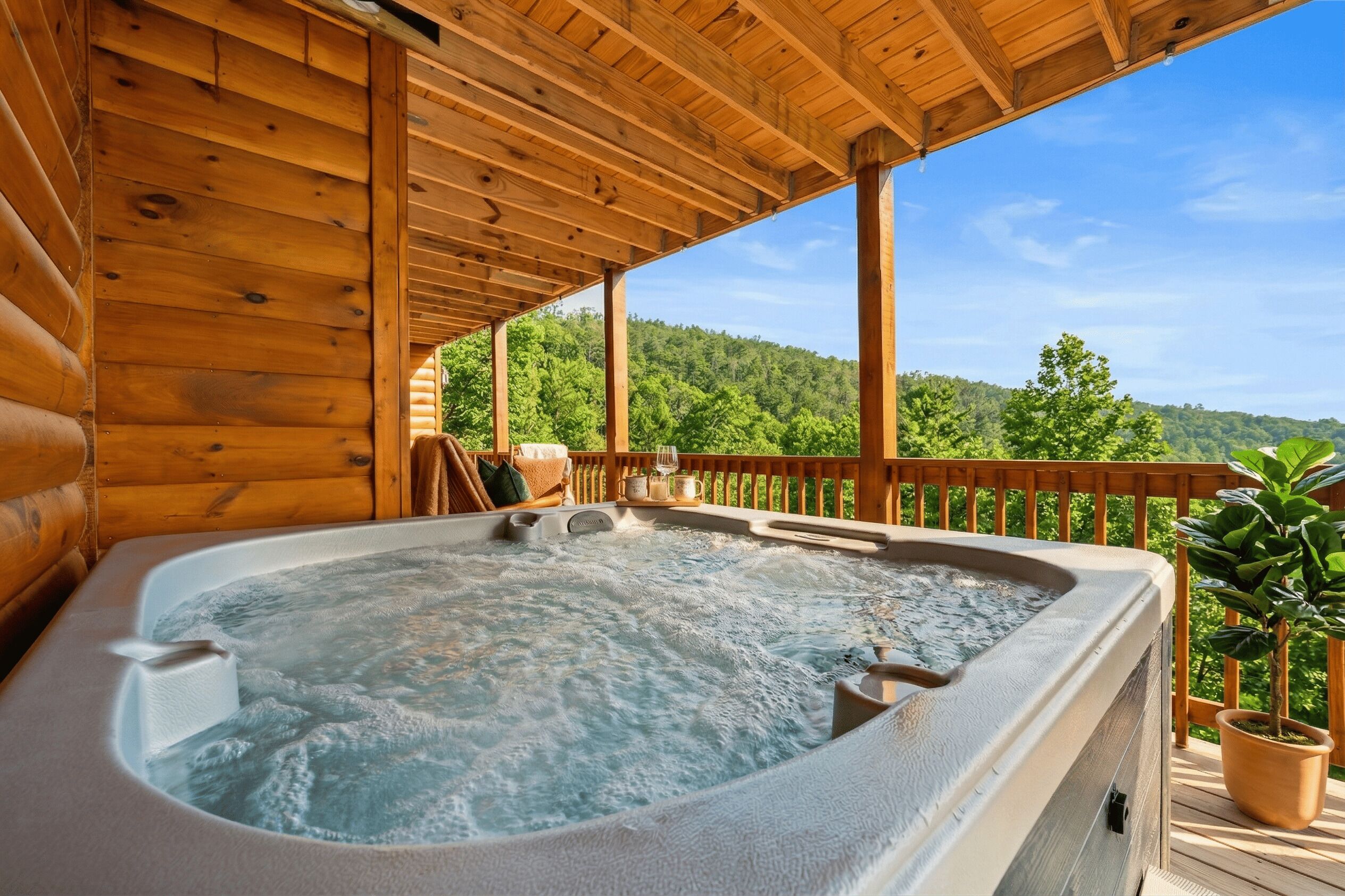 A hot tub on a wooden deck with a view of a forested hillside.