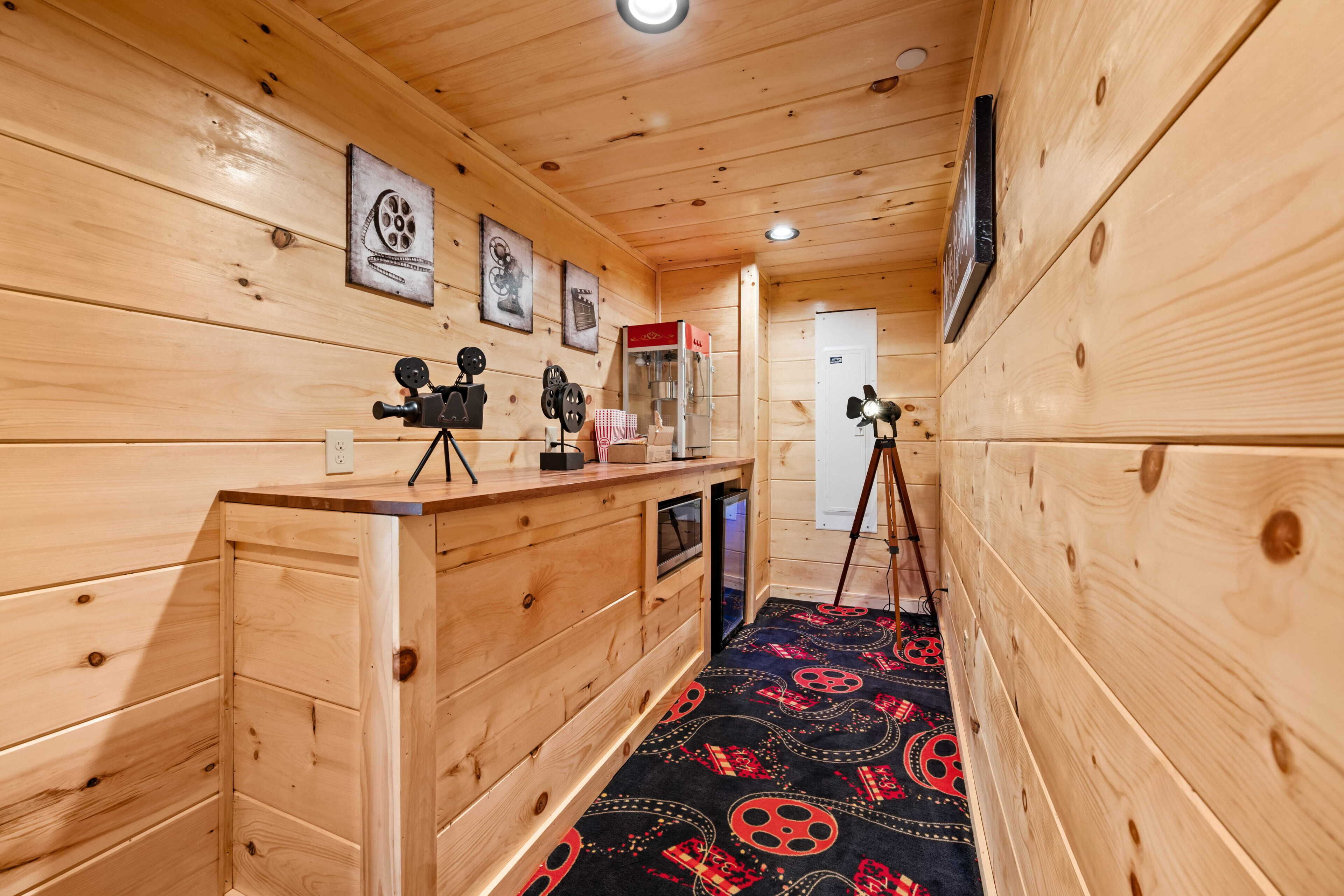 A wooden interior with a counter, camera equipment, and a patterned carpet.
