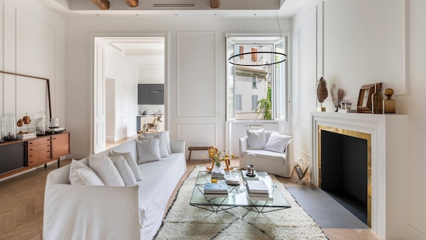A spacious living room with a glass coffee table, white sofas, a fireplace, and a view through a large window. - Casa Luce, a Burghesius home (Roma)