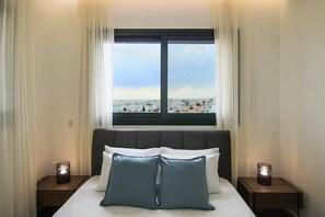 A hotel room with a bed, two bedside tables, and a window with a city view. - 131 LIM 301 - Stay Anna Residence Sea View Mais (Limassol)