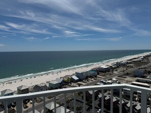 A coastal view with a beach, ocean, and a row of houses. - Bel Solé 1801 Penthouse 4 bedroom 4 bath located directly on Little Lagoon. (Gulf Shores)