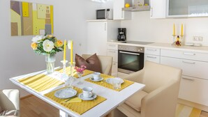 A modern kitchen with white cabinets, a microwave, and an oven. - Apartment "For 2 People, 65 m²" with Mountain View, Wi-Fi, and Air Conditioning (Scheffau am Tennengebirge)