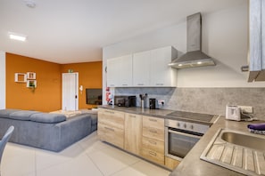 A modern kitchen with a built-in oven, microwave, and a stainless steel range hood. - Modern and cosy 2 bedroom flat with balcony BSAI1-1 (Swieqi)