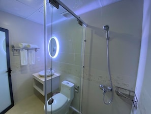 A modern bathroom with a glass-enclosed shower, a toilet, and a sink. - SEN HIDDEN HOTEL (HO CHI MINH)