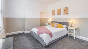 A bedroom with a bed, bedside tables, and wall art. - Host & Stay | Elmville (Scarborough)