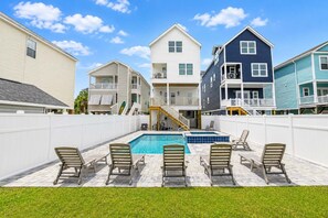 A residential area with a swimming pool, multiple houses, and a white fence. - New Construction 6 BR Beach House With Private Pool! Sea Ya'll Later (Surfside Beach)