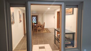 A hallway with a dining area, a welcome sign, and a shelf with books. - House right on Pine Creek, only one mile from the Snake. (Oxbow)
