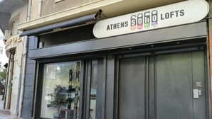 A building with a sign reading "ATHENS SOHO LOFTS". - Super 8 (Athens)