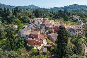 A village with traditional architecture, surrounded by greenery and hills. - Charming Villa in a Traditional Village, 3 km From the Beach of Agios Gordios (Corfu)