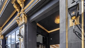 A building entrance with a black and gold facade, large glass doors, and a tiled entrance area. - Park Hotel 1BR Suite 310 (Chattanooga)