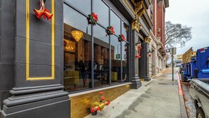 A building facade with large windows, a fire hydrant, and a street with a parked truck. - Park Hotel 2BR Suite 406 (Chattanooga)