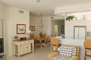 A compact living space with a dining area, kitchenette, and seating area. - Regatta at Vanderbilt Beach | Pool | Walk to Gulf (Naples)