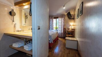 A bathroom with a sink, mirror, and towel rack.