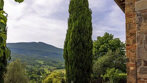A stone building with a view of a mountainous landscape. - CASA VECCIANO essence of Tuscany (Toscana)